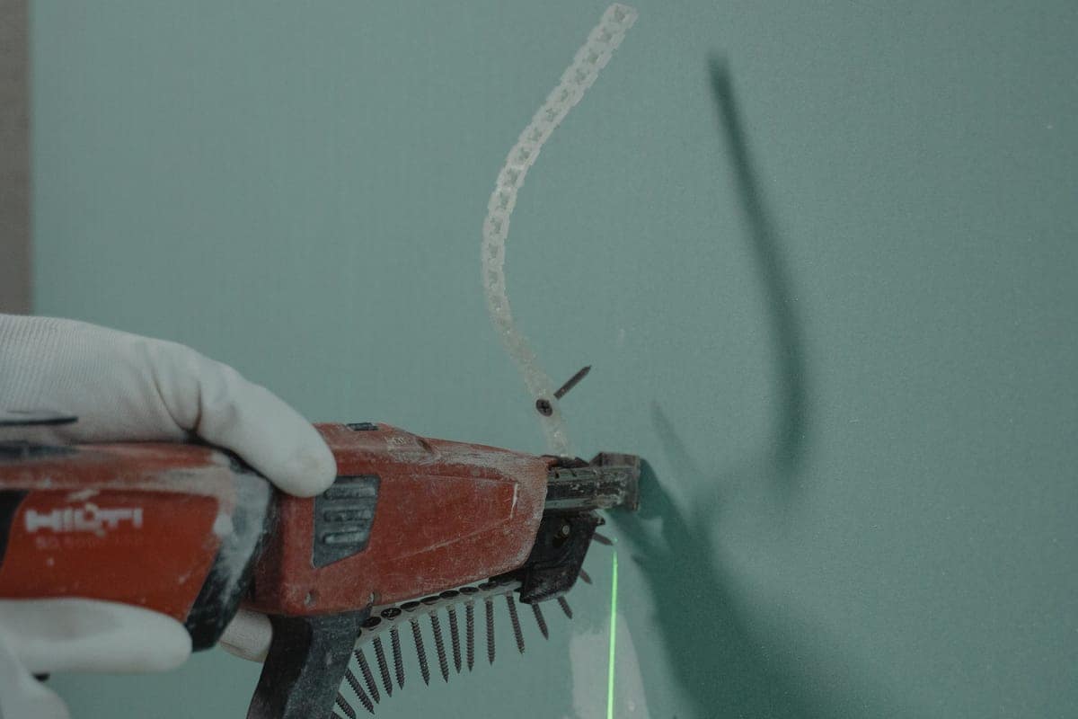 Levigatrice per giunti al lavoro su una parete in lastre idrorepellenti
